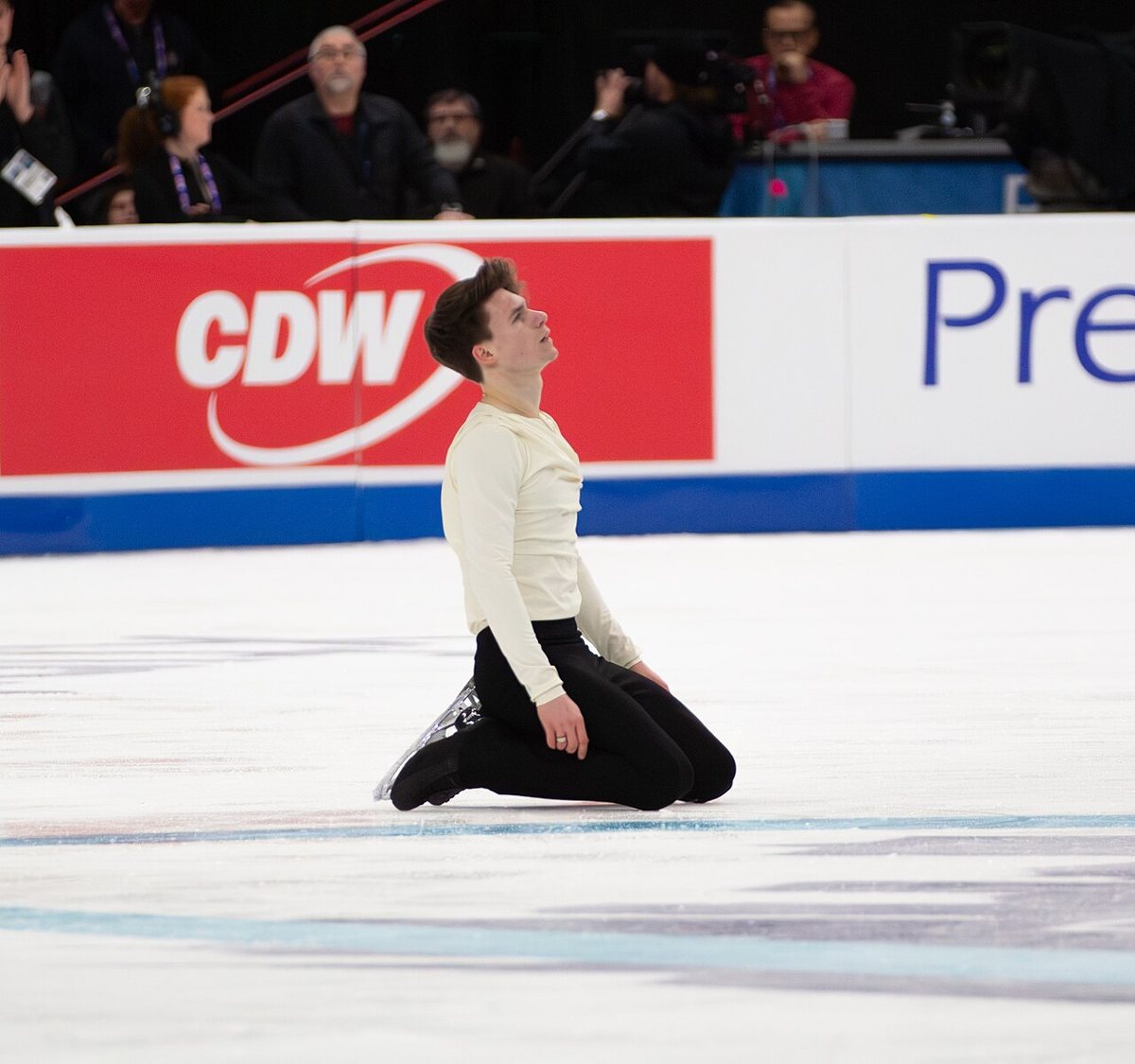 Figure skater Maxim Naumov kneeling on the ice after his short program at the 2026 national championships